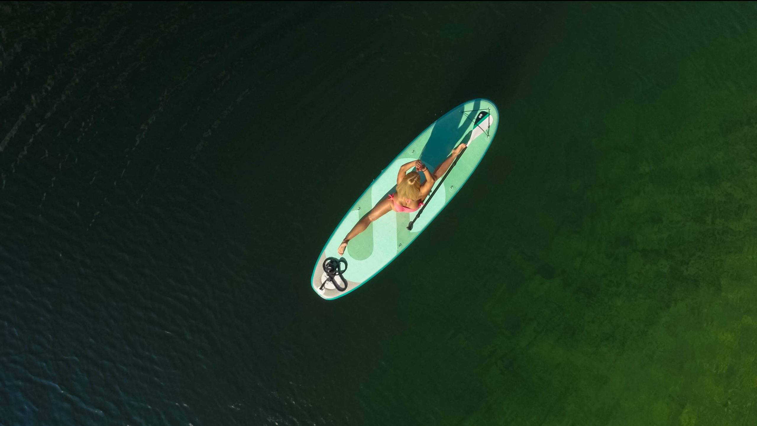 ragazza mentre fa yoga sopra un sup sul Lago di Como